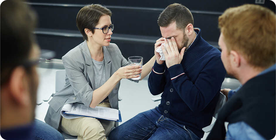 A counsellor offering support to a crying person